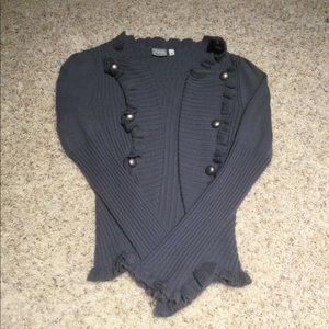 Sweater with ruffled sleeves and button detail.